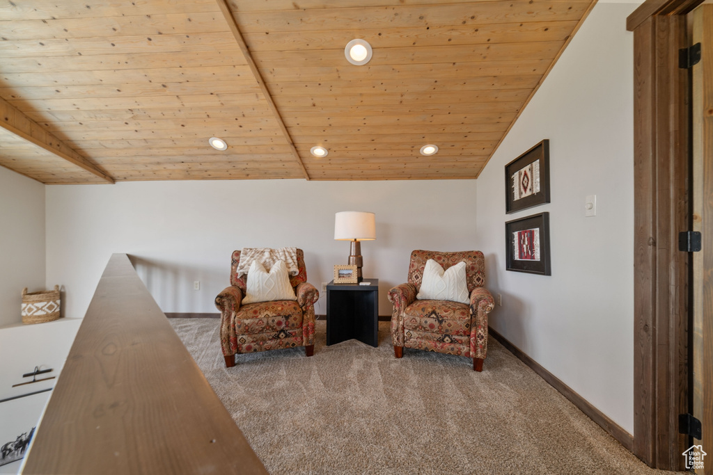 Living area with carpet, wooden ceiling, recessed lighting, and baseboards
