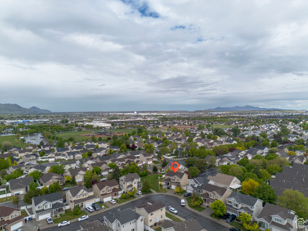 Aerial perspective of suburban area featuring a mountain backdrop
