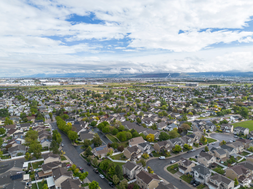 Aerial view of property and surrounding area with nearby suburban area