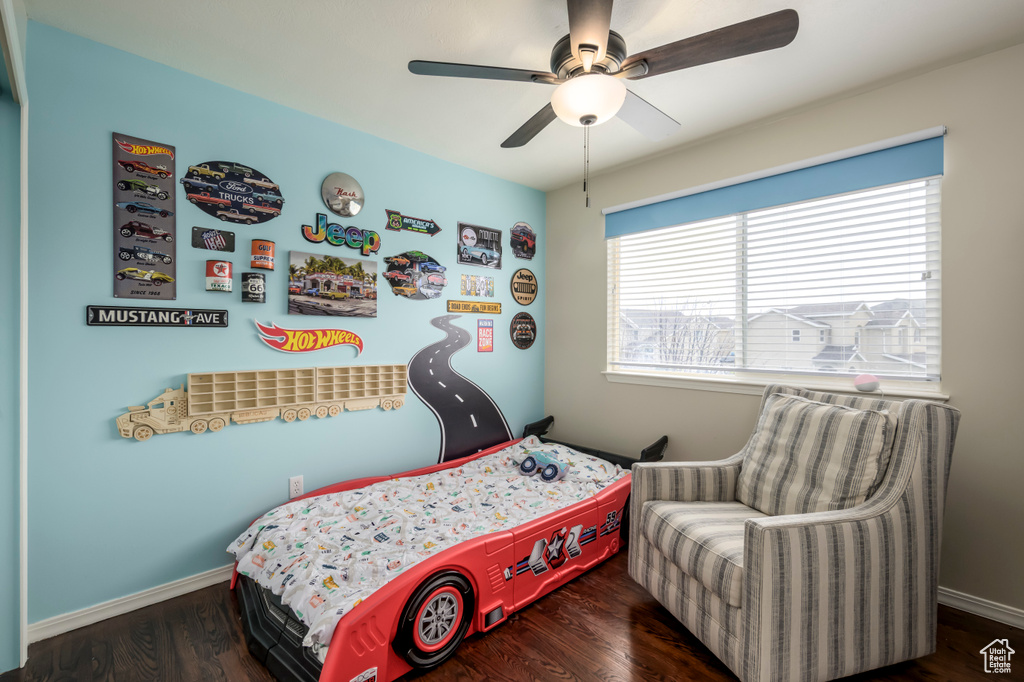 Bedroom with wood finished floors, ceiling fan, and baseboards