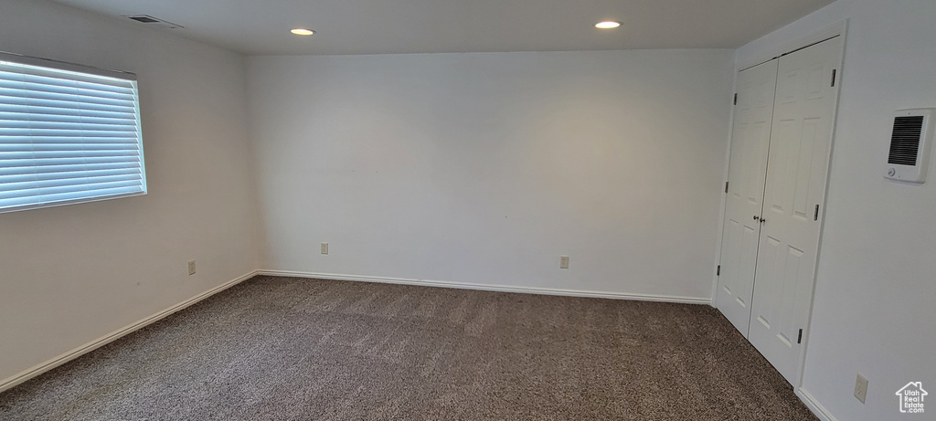 Unfurnished bedroom featuring carpet floors, recessed lighting, baseboards, and a closet