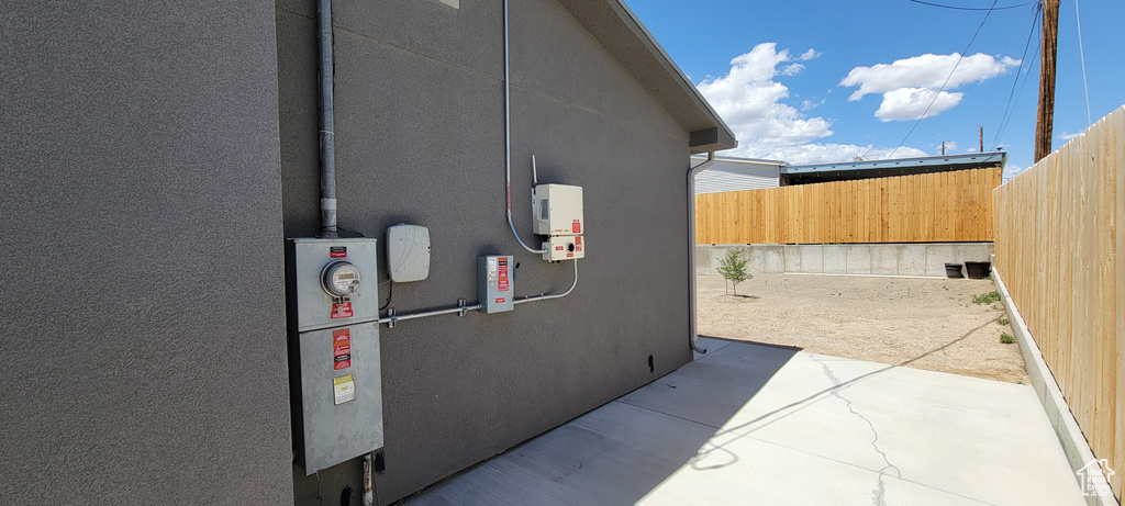 View of home\'s exterior featuring fence and stucco siding