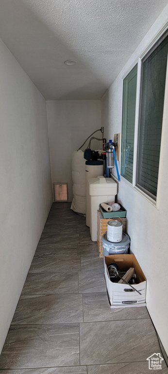 Laundry room featuring a textured ceiling and wood finished floors