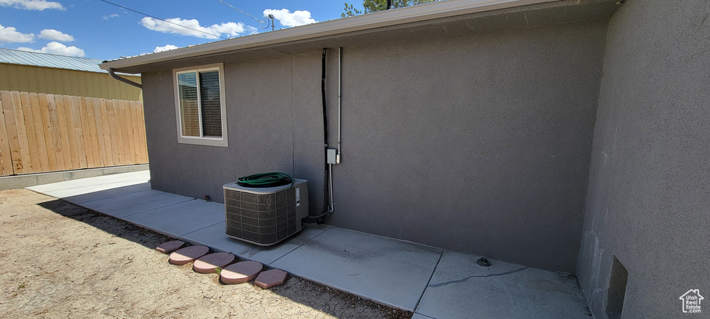 View of patio with fence and central AC unit