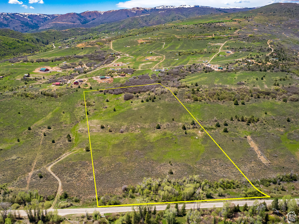 Overview of rural landscape with property parcel outlined and mountains