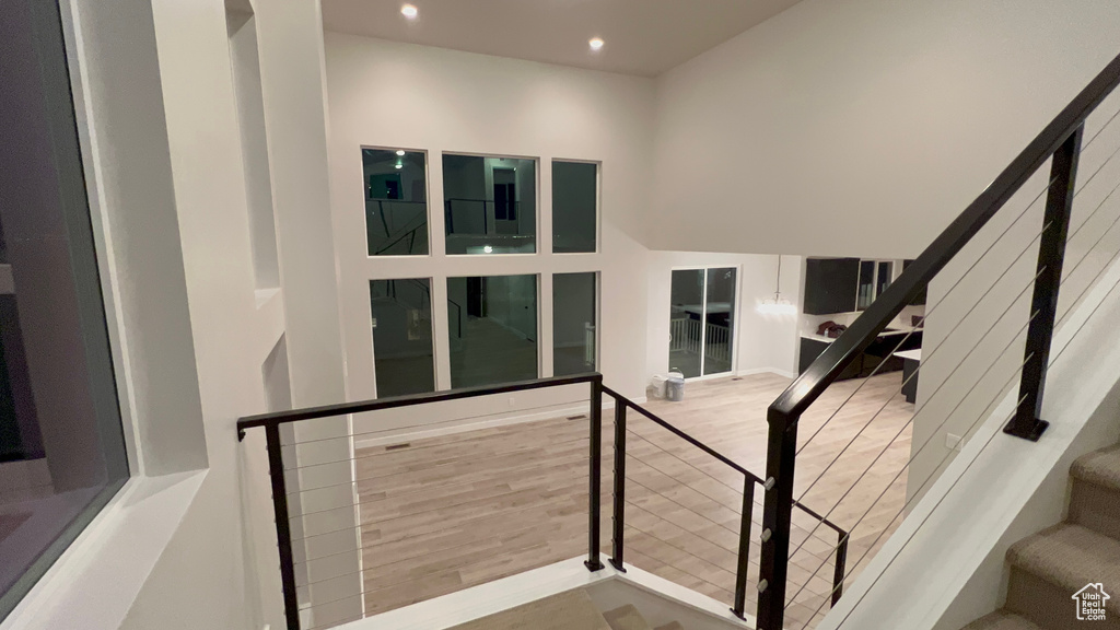 Stairs featuring recessed lighting and wood finished floors