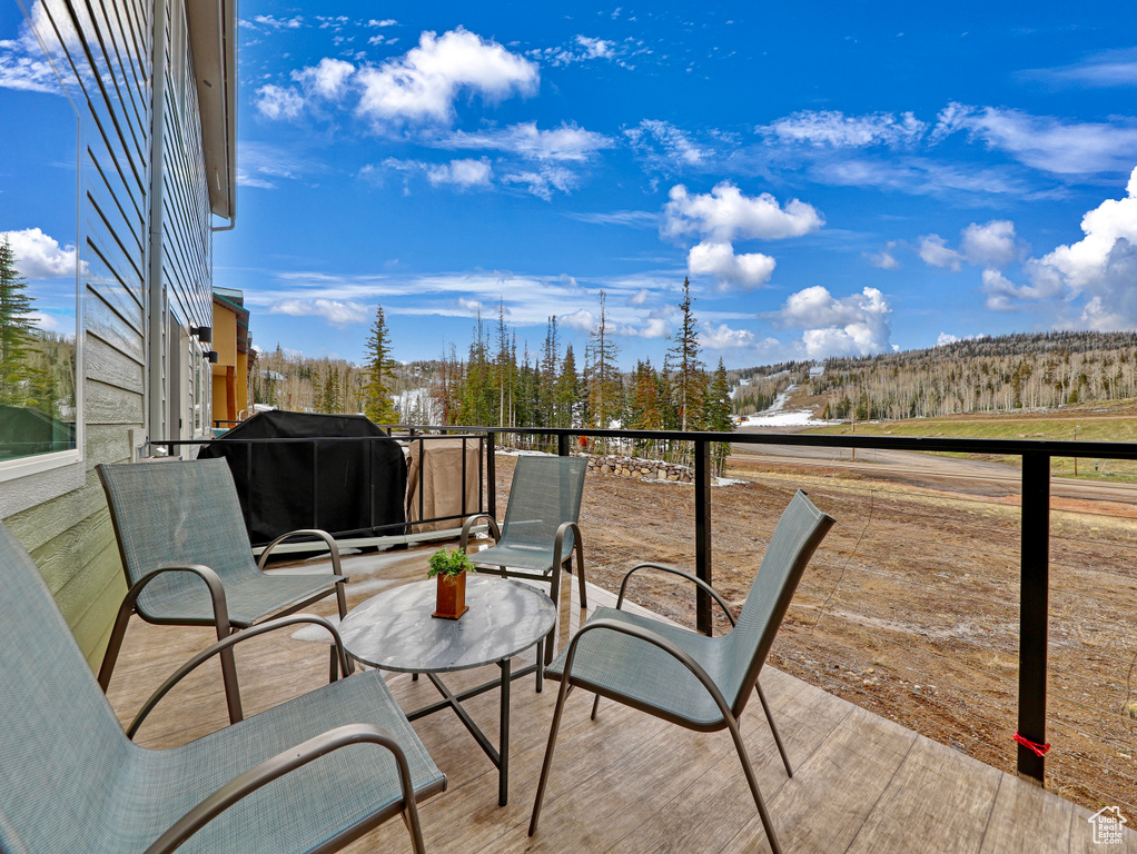 Wooden deck featuring a grill