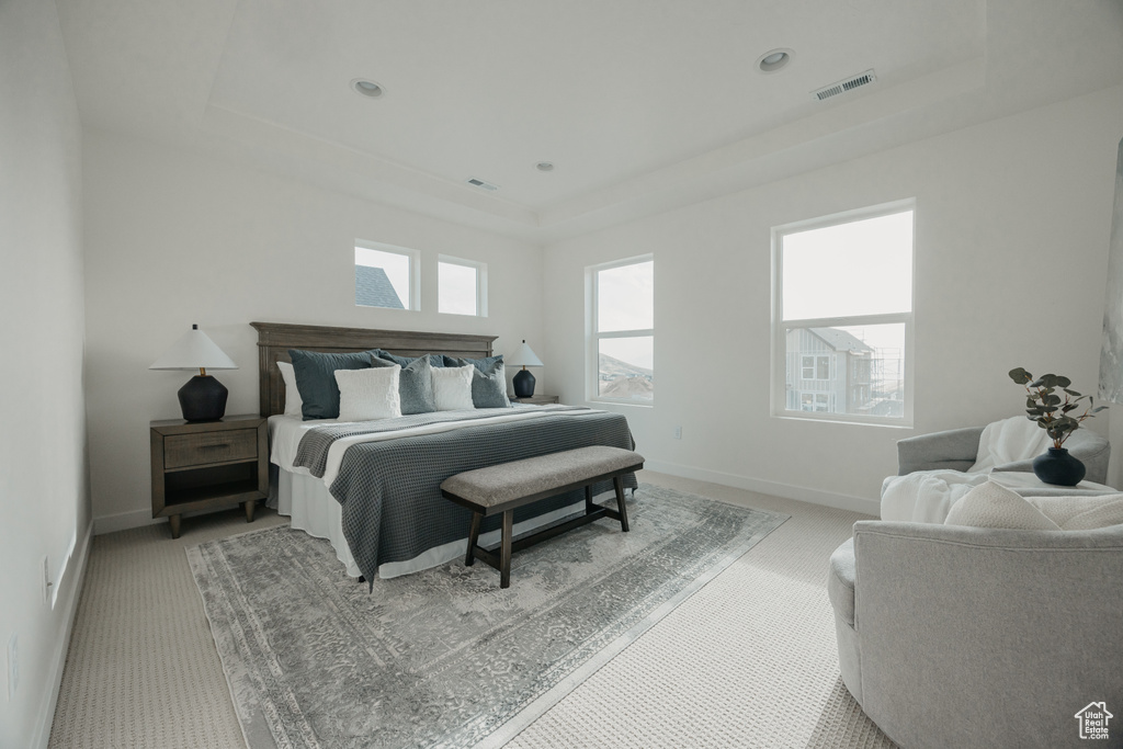 Bedroom with a tray ceiling, light colored carpet, baseboards, and recessed lighting