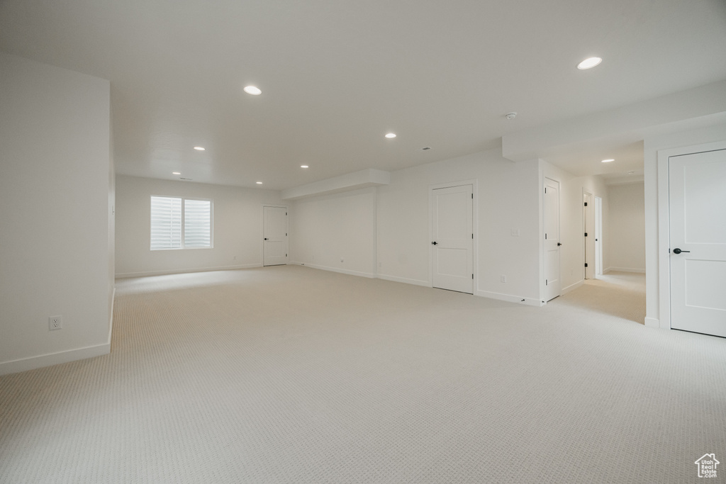 Empty room with recessed lighting, light carpet, and baseboards