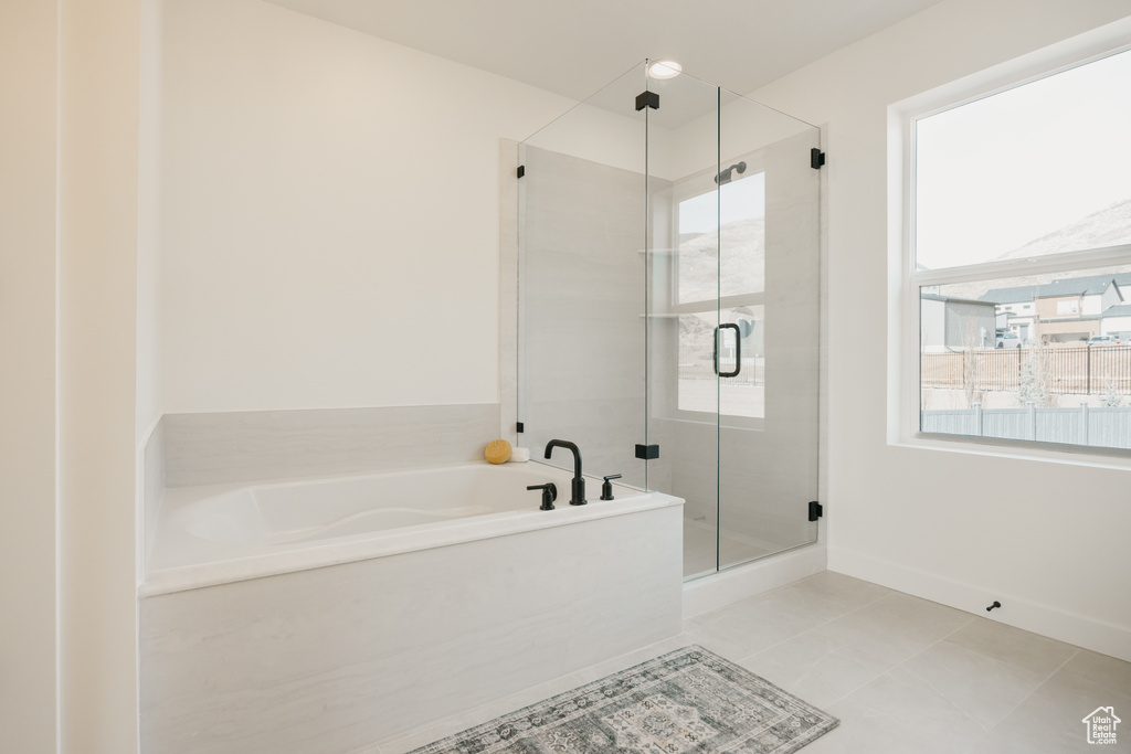 Bathroom featuring a shower stall, a bath, and tile patterned floors