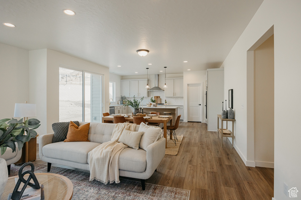 Living area featuring wood finished floors, recessed lighting, and baseboards