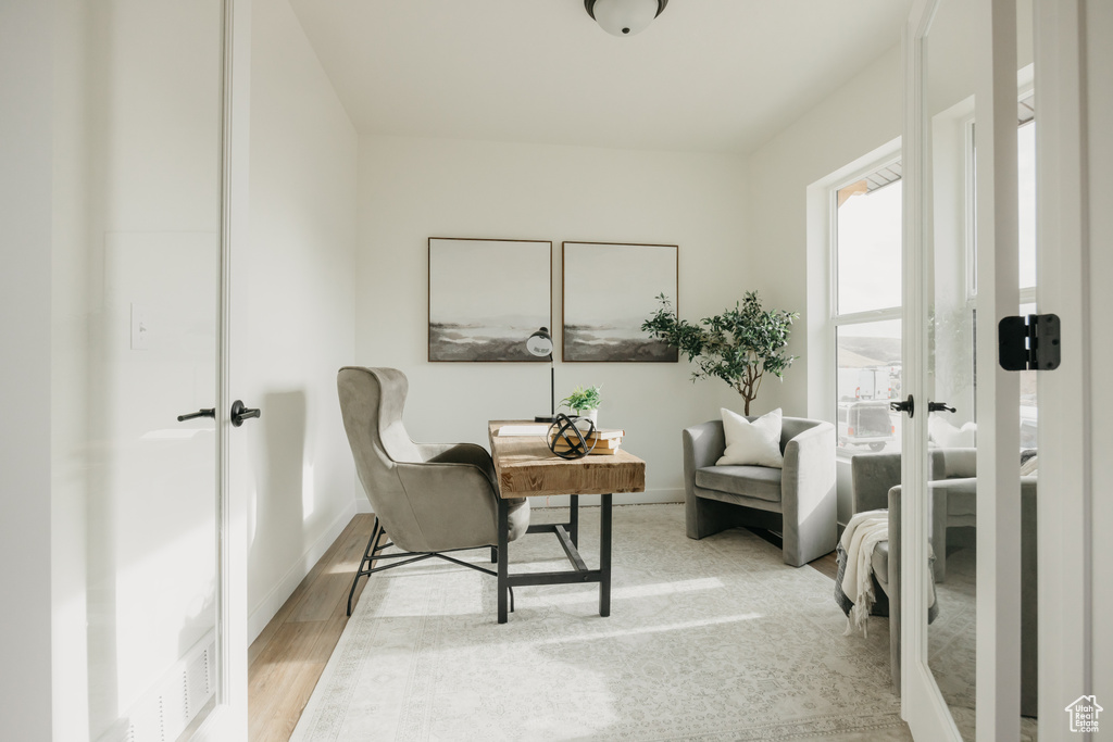 Living area featuring baseboards and light wood-type flooring