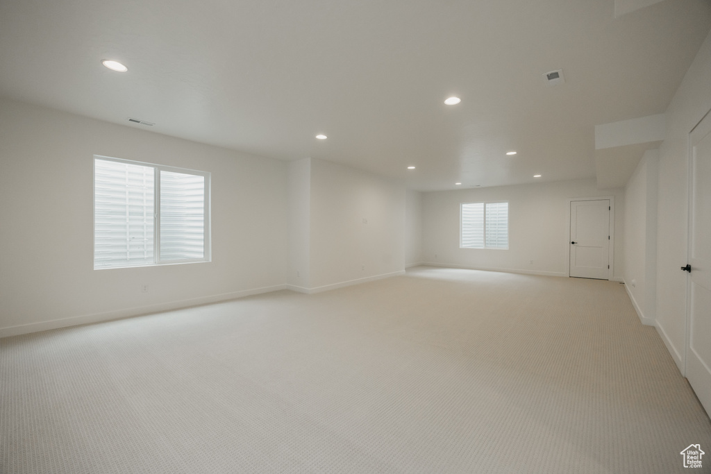 Unfurnished room featuring recessed lighting, light colored carpet, and baseboards