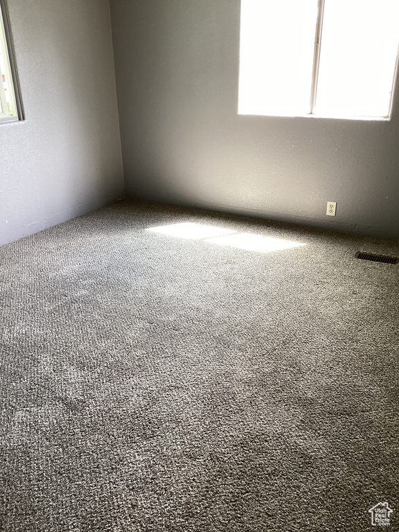 Spare room featuring carpet flooring