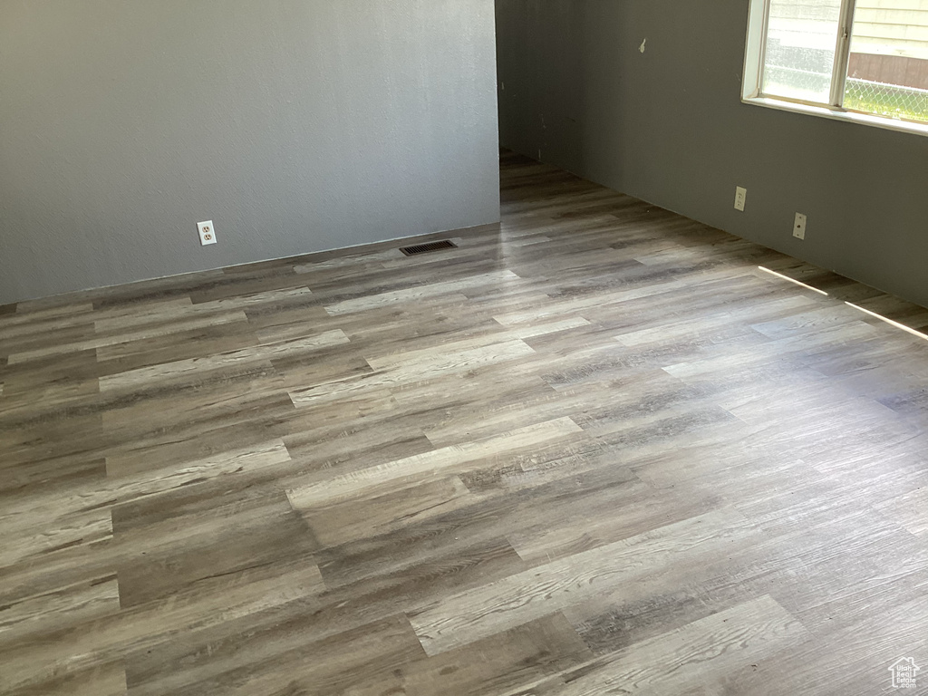 Empty room featuring wood finished floors