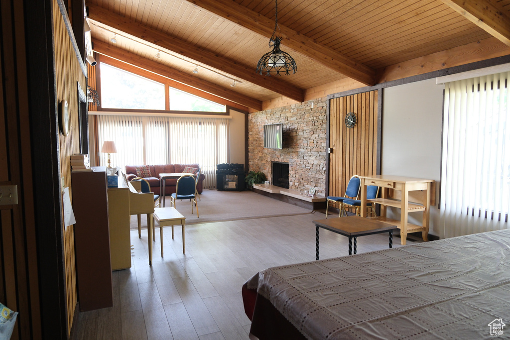 Bedroom with a fireplace, wood finished floors, and wood ceiling