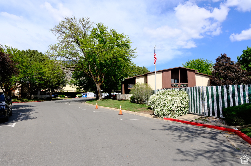 View of asphalt street featuring curbs