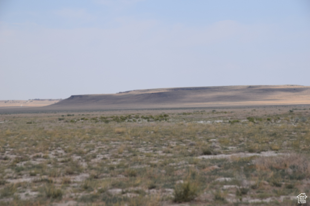 View of yard featuring a mountain view, a view of countryside, and view of desert