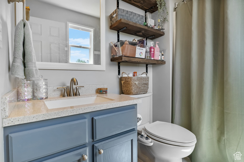 Full bathroom with toilet and vanity