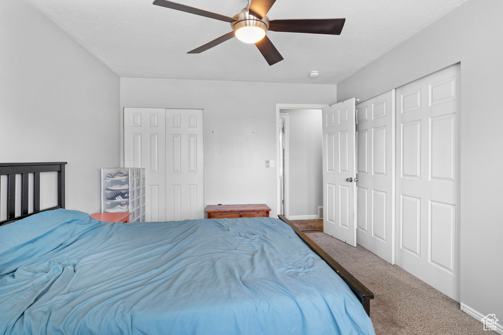 Bedroom with carpet, baseboards, and a ceiling fan