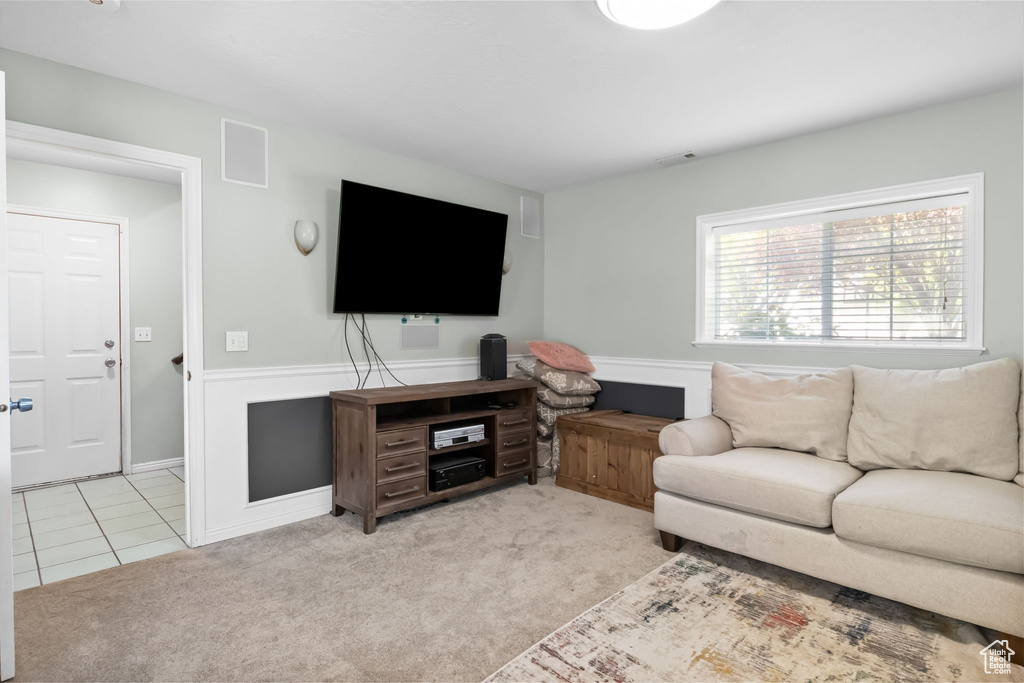 Living room with light carpet and light tile patterned floors