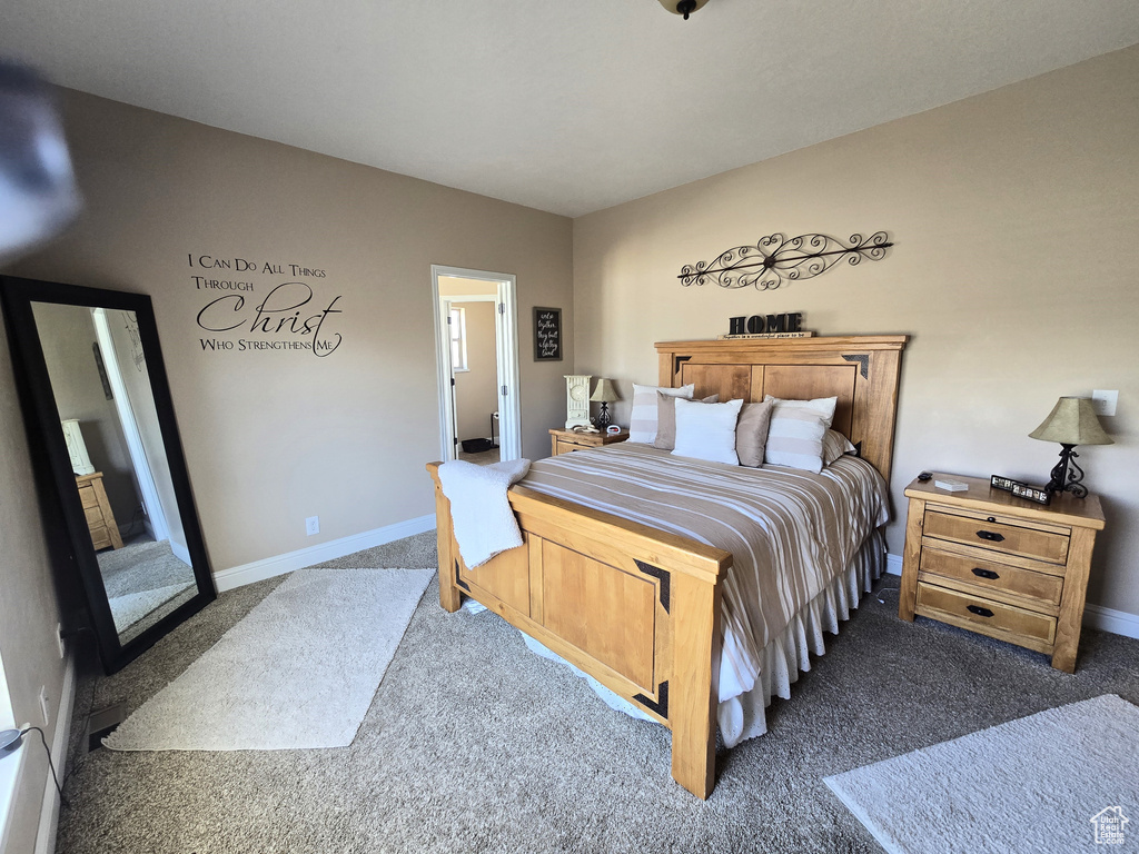 Carpeted bedroom featuring baseboards