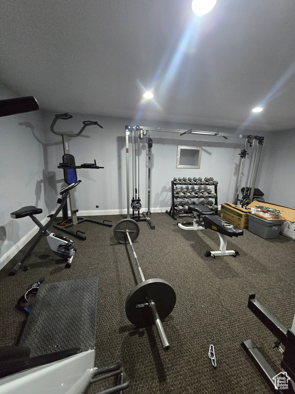 Workout area with baseboards and recessed lighting