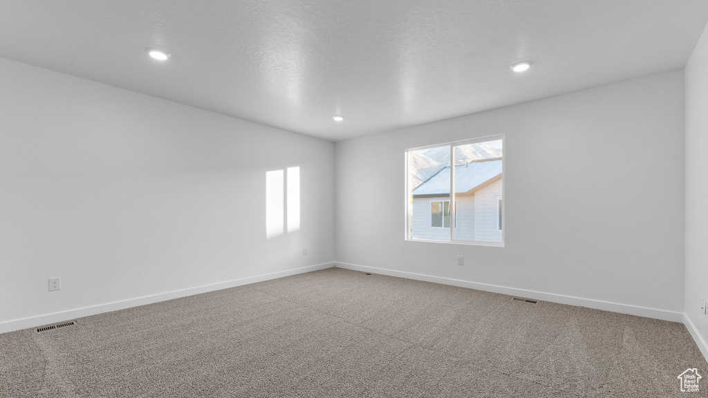 Unfurnished room with baseboards, carpet, and recessed lighting