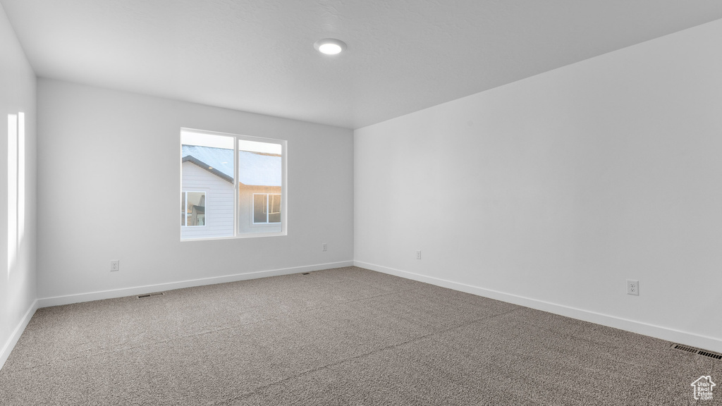 Empty room featuring carpet floors and baseboards
