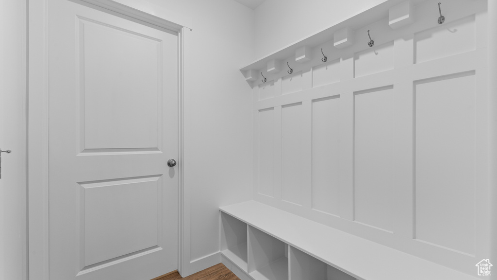 Mudroom with baseboards and wood finished floors