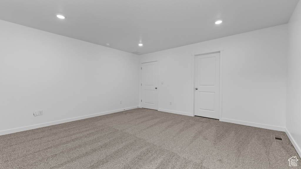 Unfurnished room featuring carpet floors, recessed lighting, and baseboards
