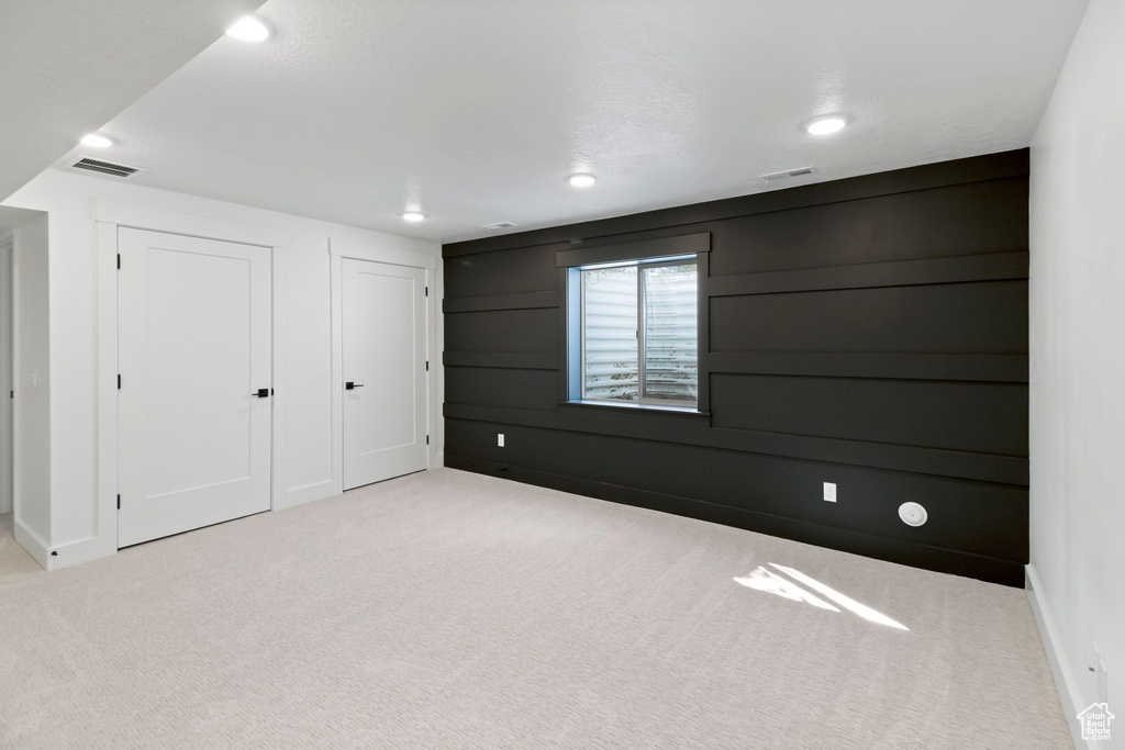 Carpeted spare room featuring recessed lighting and baseboards