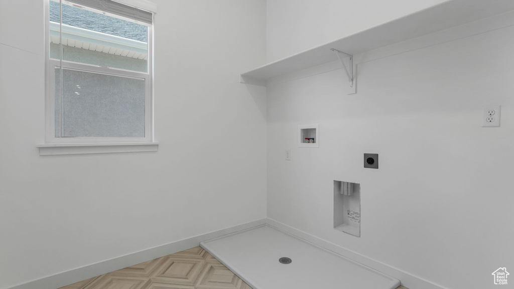 Laundry area with hookup for a washing machine, hookup for an electric dryer, and baseboards