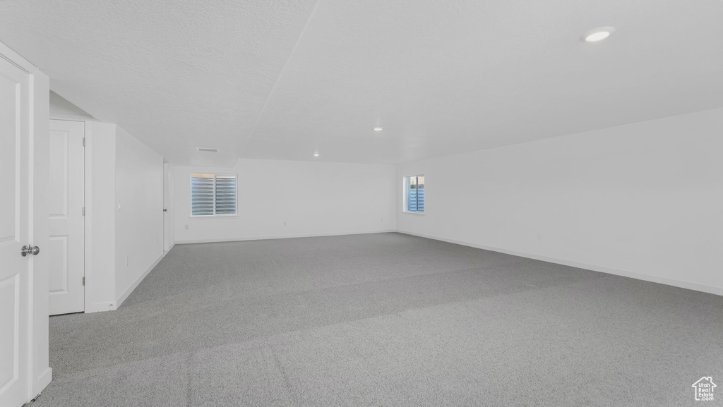 Additional living space featuring carpet, recessed lighting, and baseboards