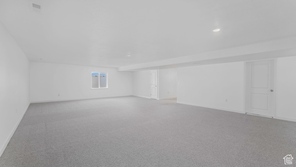Additional living space with baseboards and recessed lighting