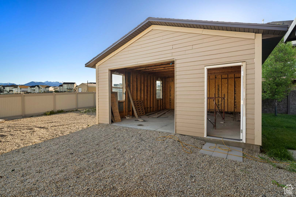 View of outbuilding featuring fence and an outdoor structure