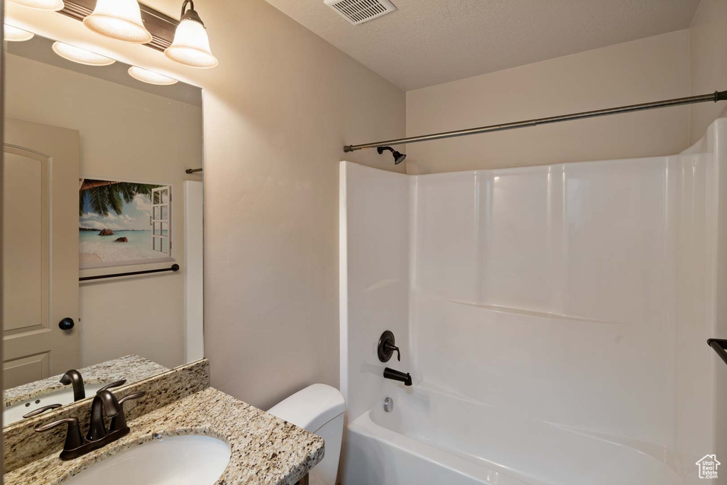 Full bathroom with toilet, shower / washtub combination, and vanity