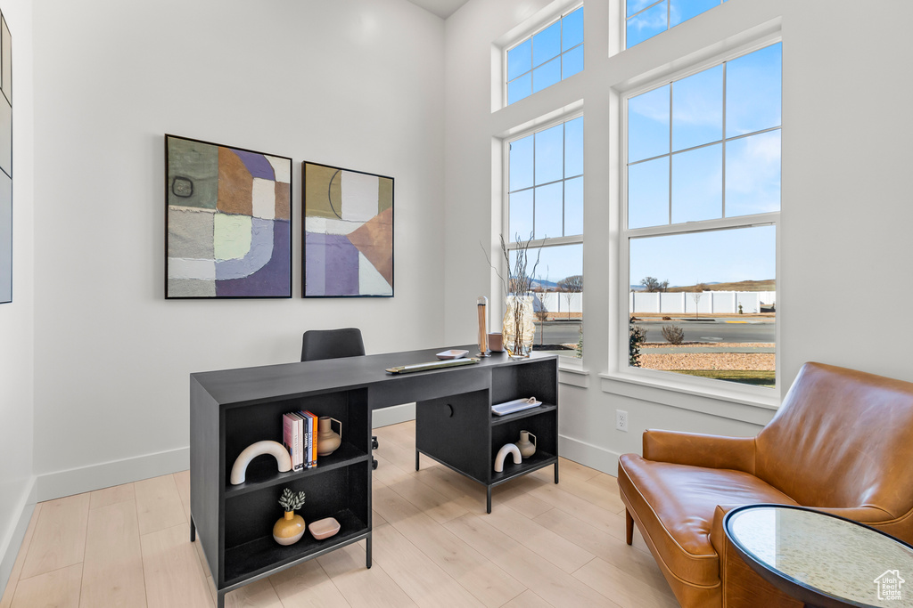 Home office featuring baseboards and light wood-style flooring