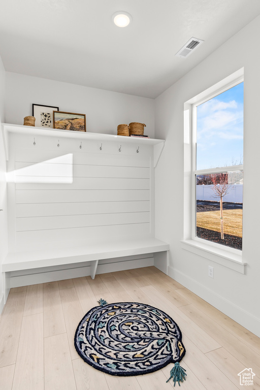 Mudroom with wood finished floors and baseboards