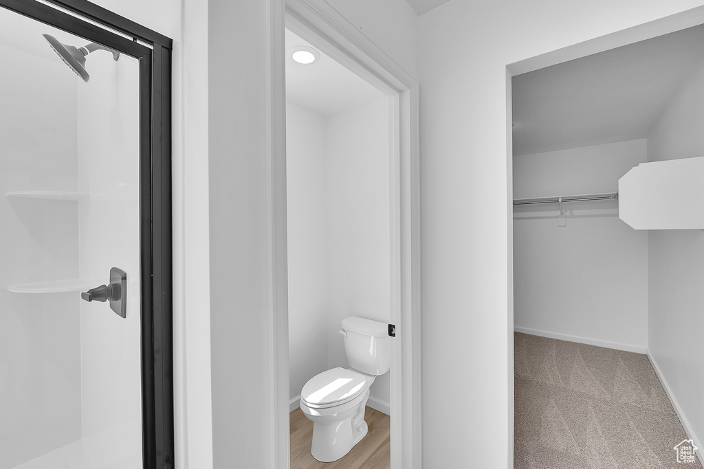 Bathroom featuring toilet, baseboards, and a shower