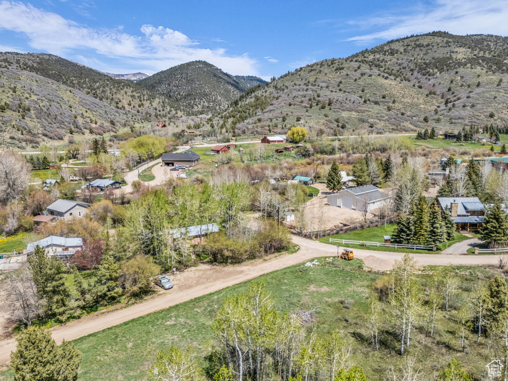 Aerial view of property\'s location featuring a mountain backdrop