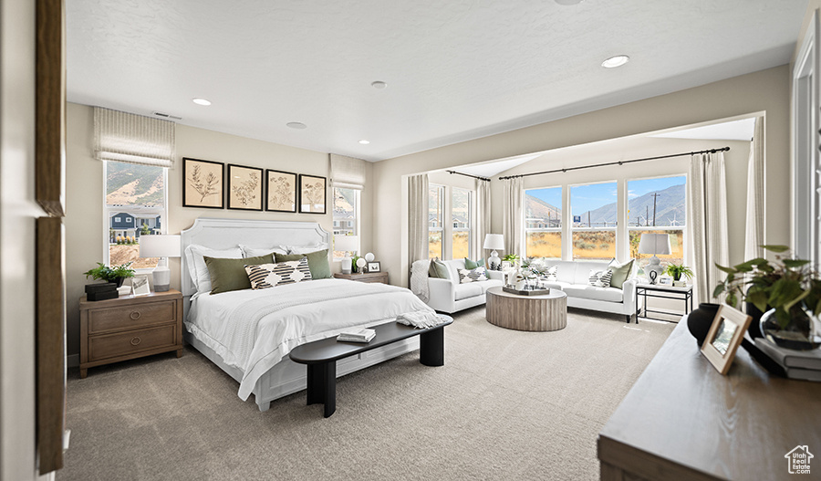 Bedroom with carpet floors, recessed lighting, and a mountain view