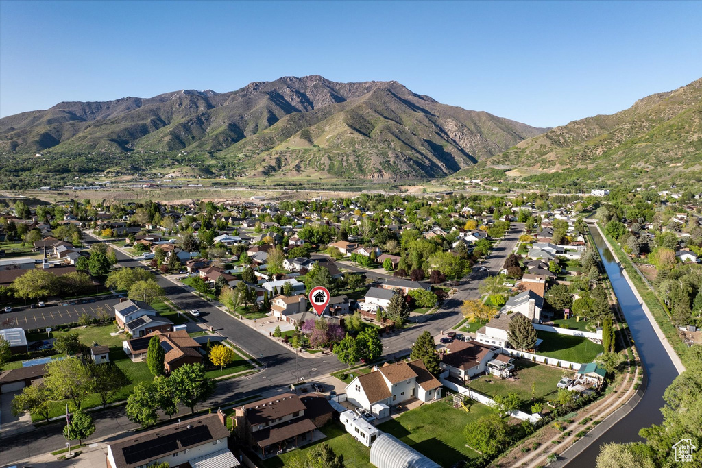 Aerial view of property's location featuring nearby suburban area and a mountain backdrop