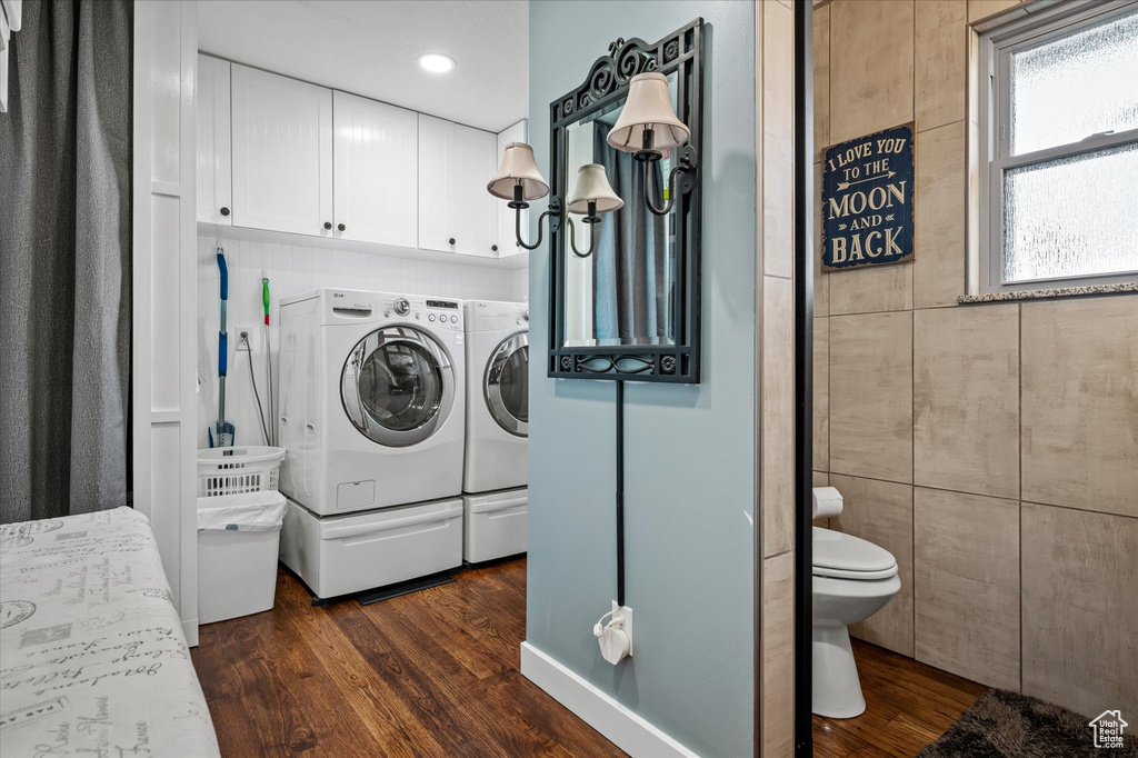 Washroom featuring washer and clothes dryer, dark wood-type flooring, and recessed lighting