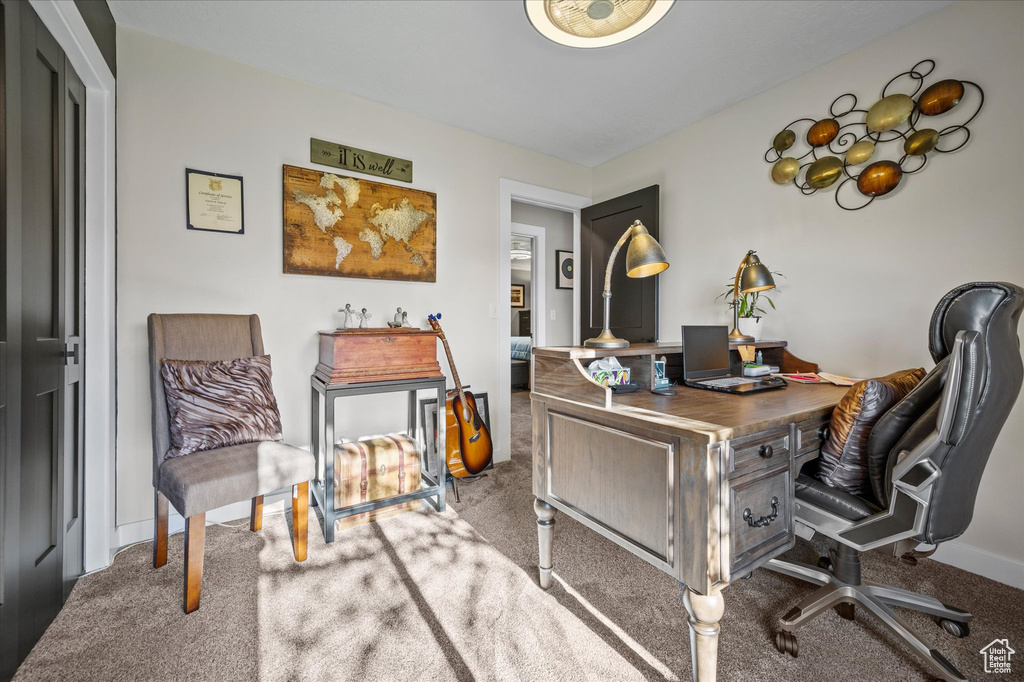 Office space with carpet and baseboards