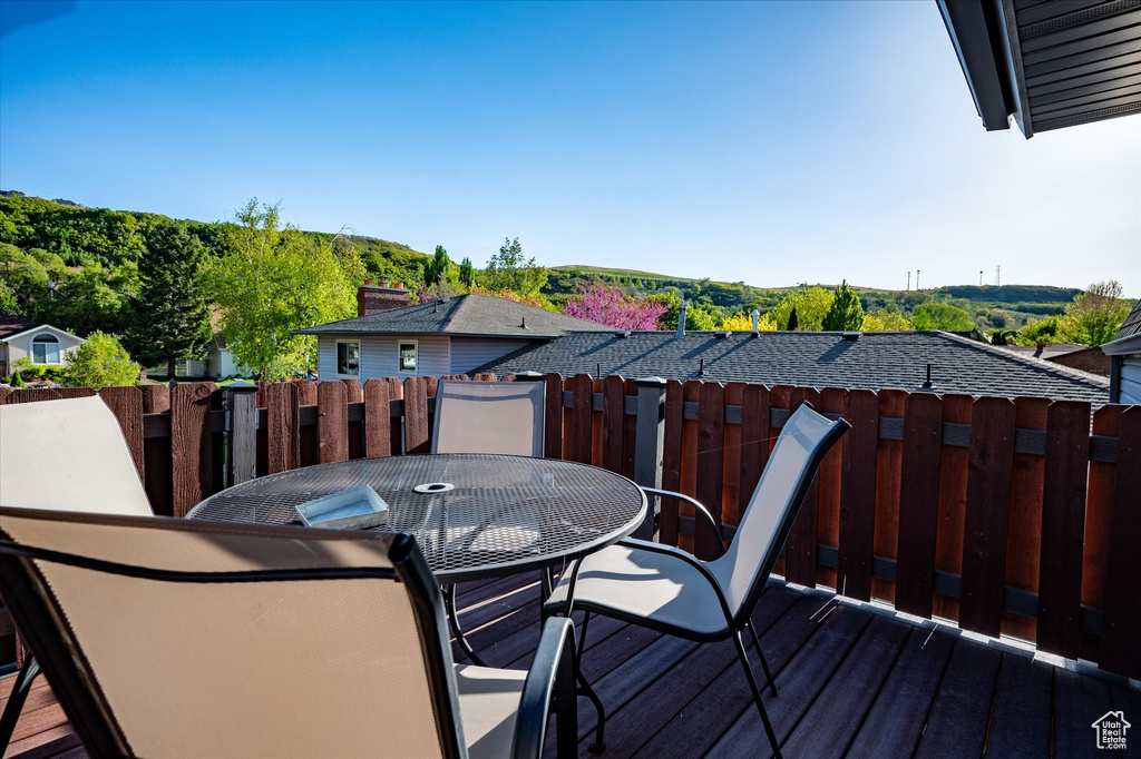 Wooden terrace with fence and outdoor dining space
