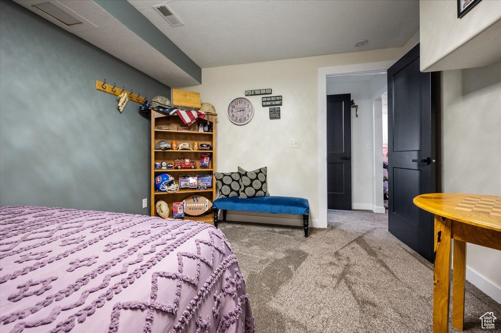 Carpeted bedroom featuring baseboards