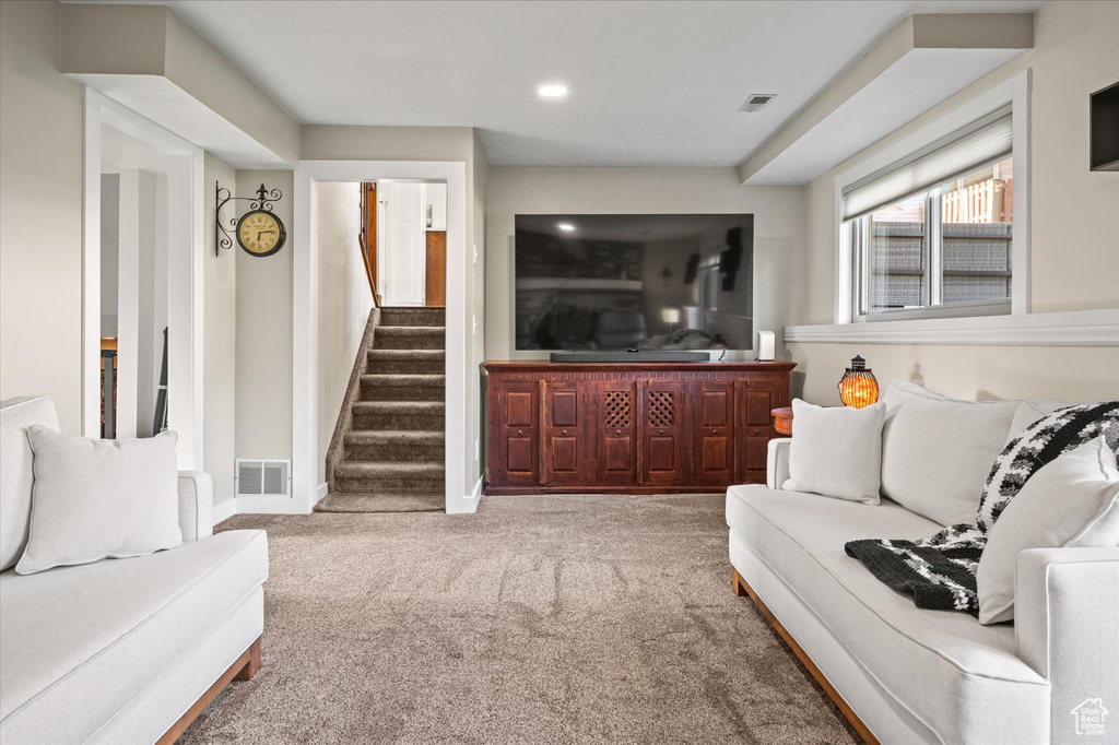 Living room with carpet, stairs, recessed lighting, and baseboards