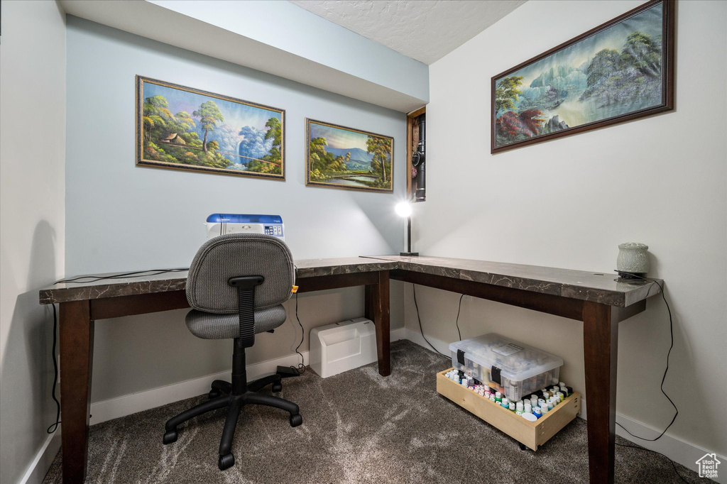 Carpeted office with baseboards
