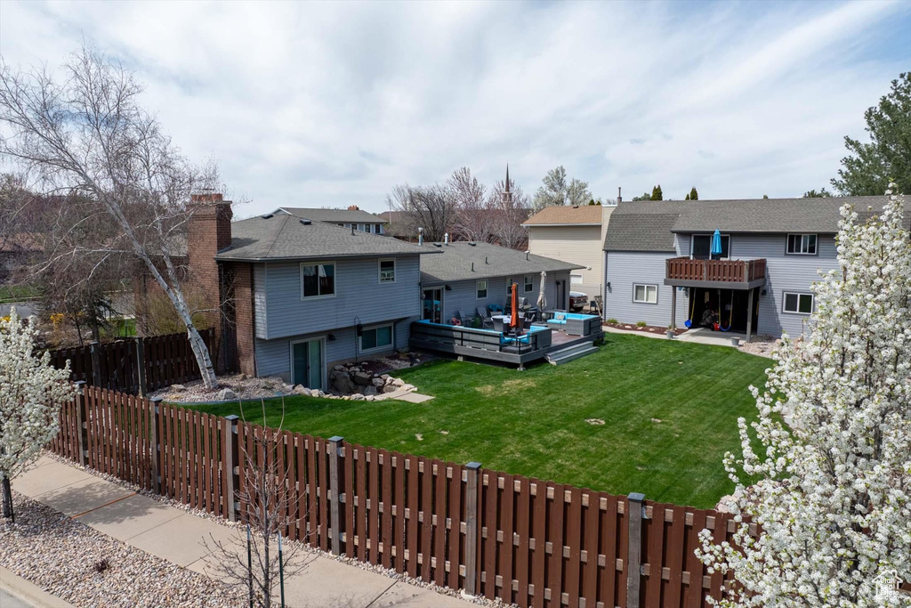 Rear view of property with a wooden deck, an outdoor hangout area, and a chimney
